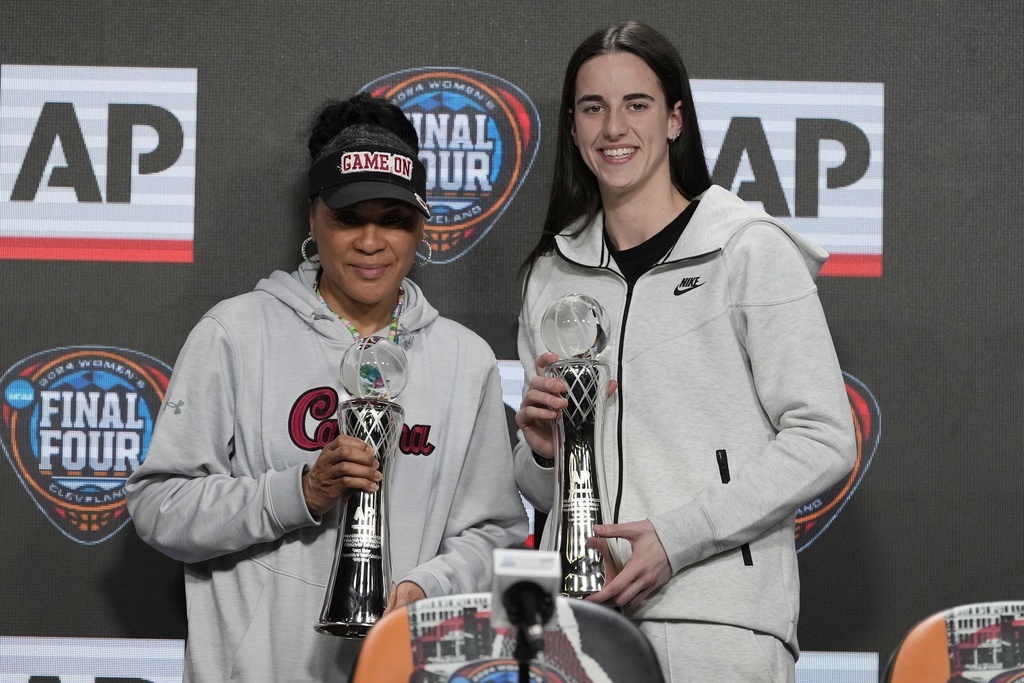 Caitlin Clark (R) and Dawn Staley pose with their awards after the NCAA Womens Coach and Player of the Year announcement.