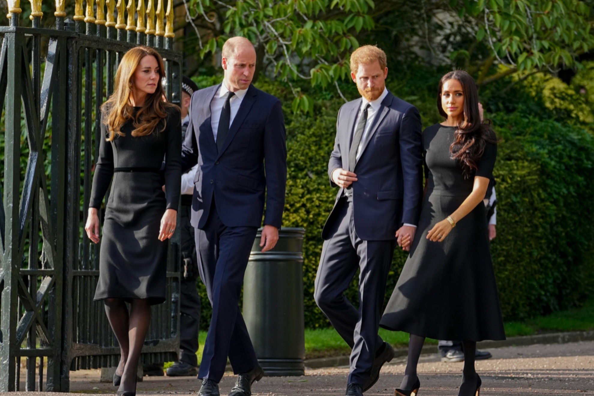 From left: Kate Middleton, Prince William, Prince Harry, and Meghan Markle, viewing the floral tributes for the late Queen Elizabeth II.