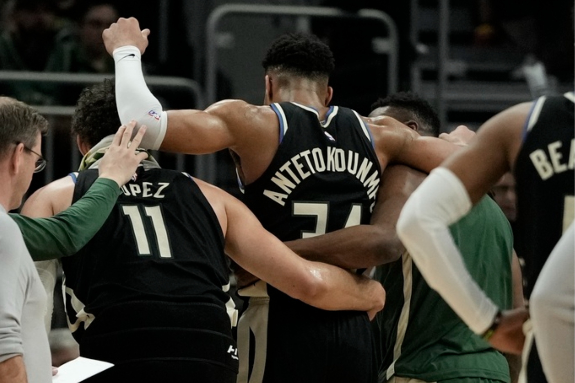 Giannis Antetokounmpo is helped off the court during the second half of the game against the Boston Celtics.