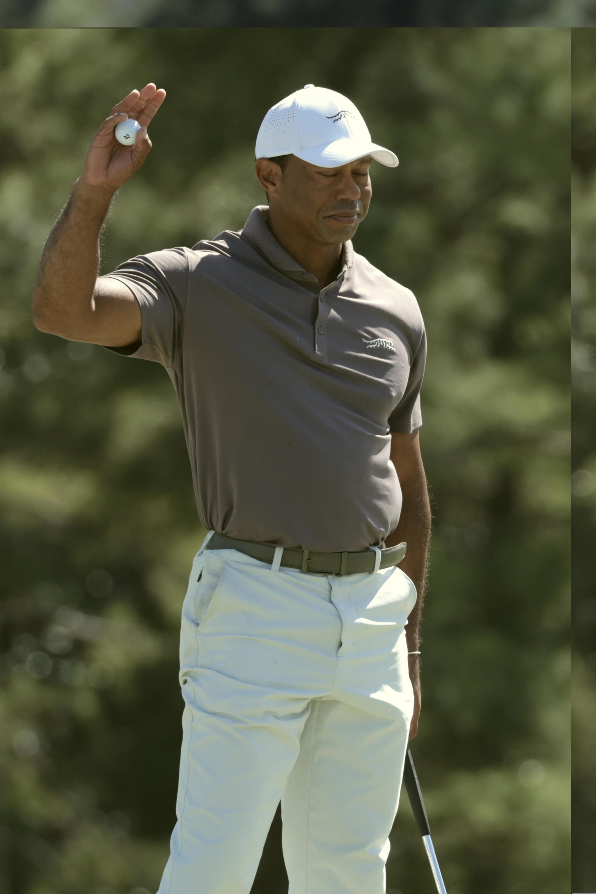 Tiger Woods gestures on the 18th green during the second round of the Masters