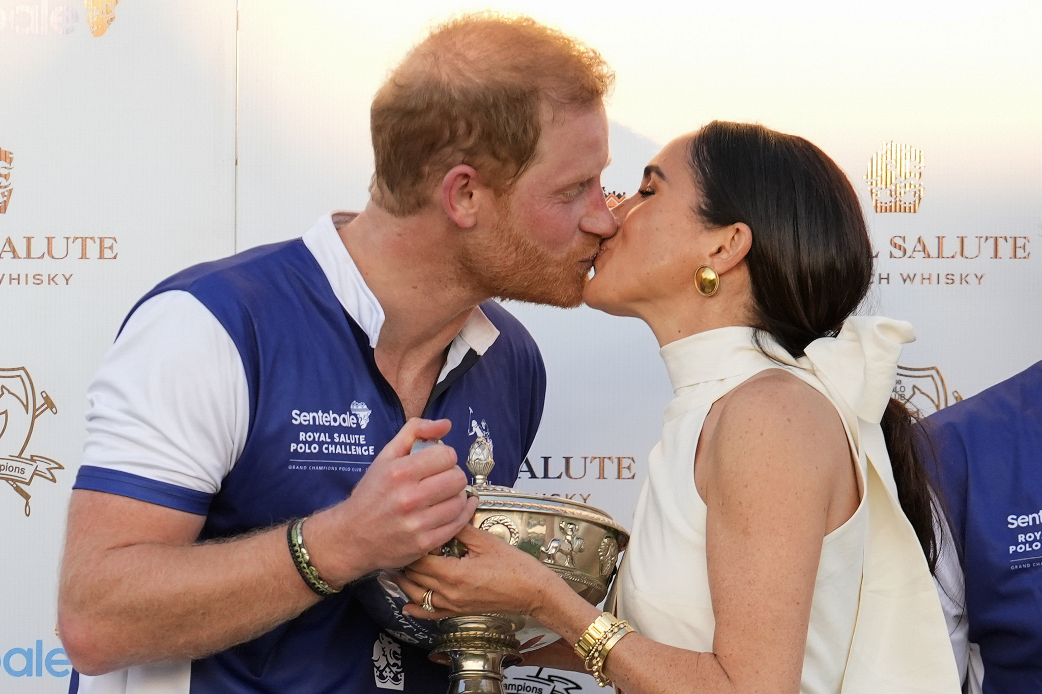 Prince Harry and wife Meghan Markle, Duchess of Sussex, kiss