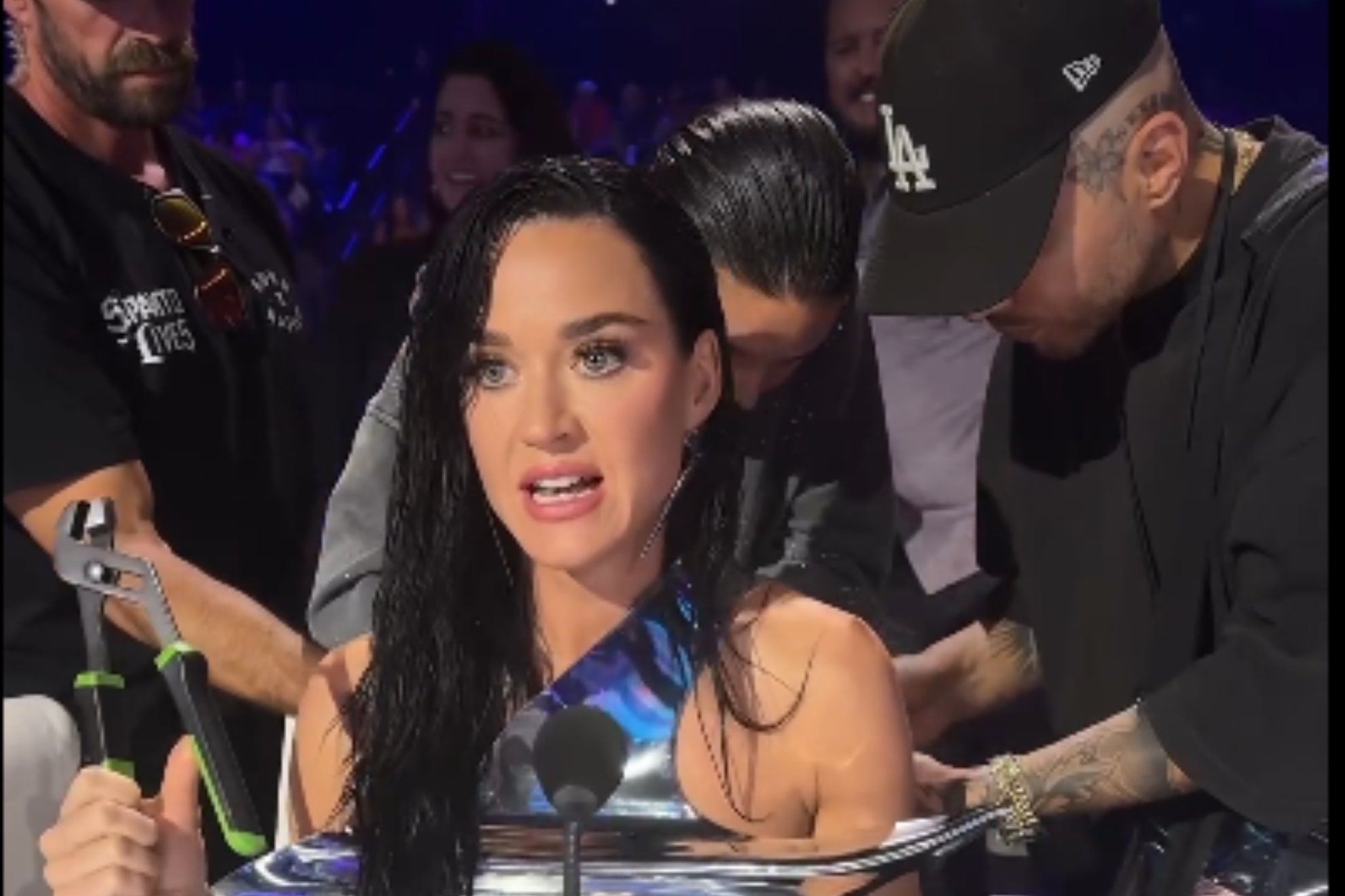 Katy Perry slips up during a live show and falls out of the top of her outlandish outfit