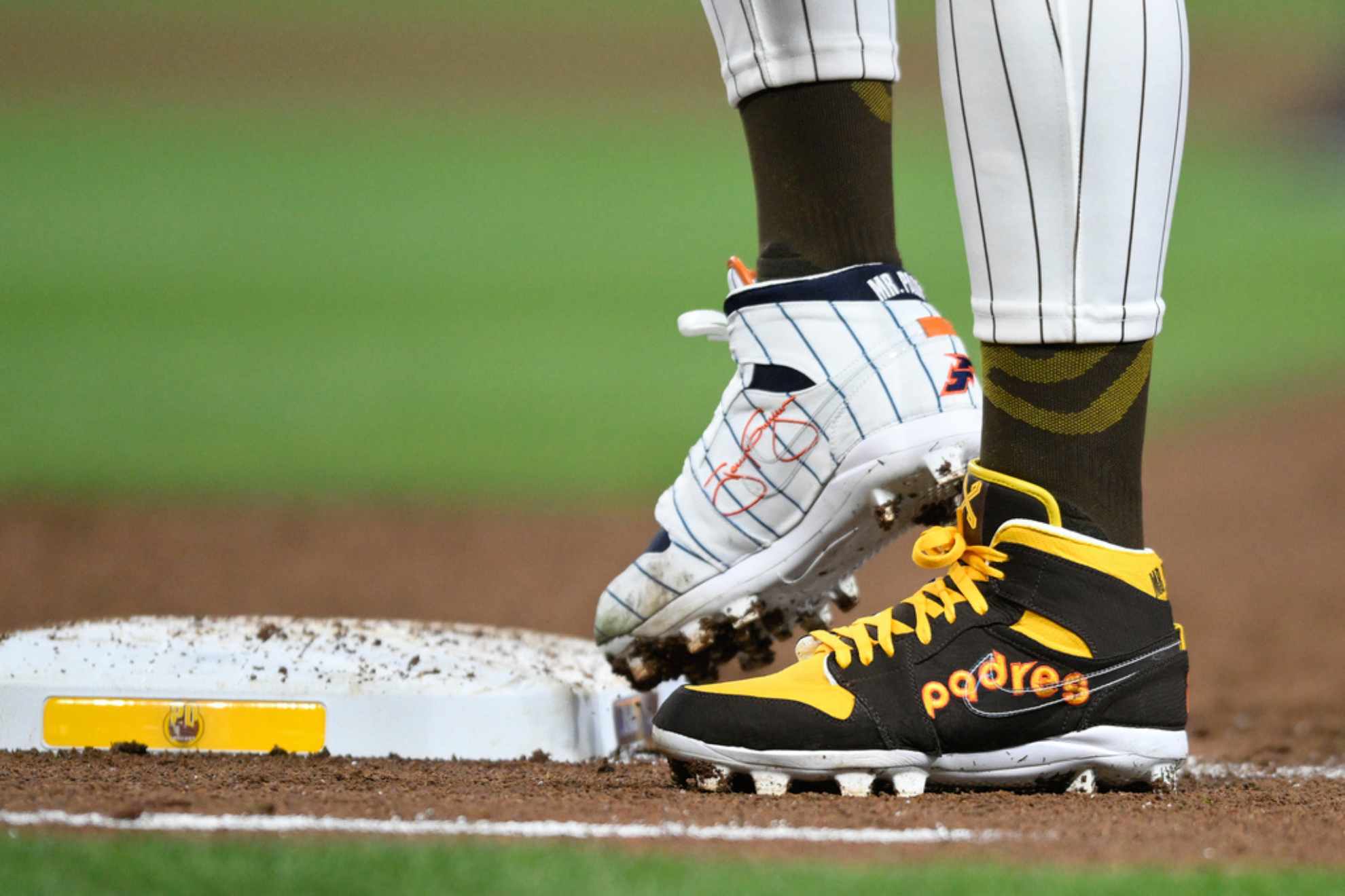 San Diego Padres Fernando Tatis Jr. (23) wears cleats commemorating the Padress 1980s and 1990s teams during a baseball game /