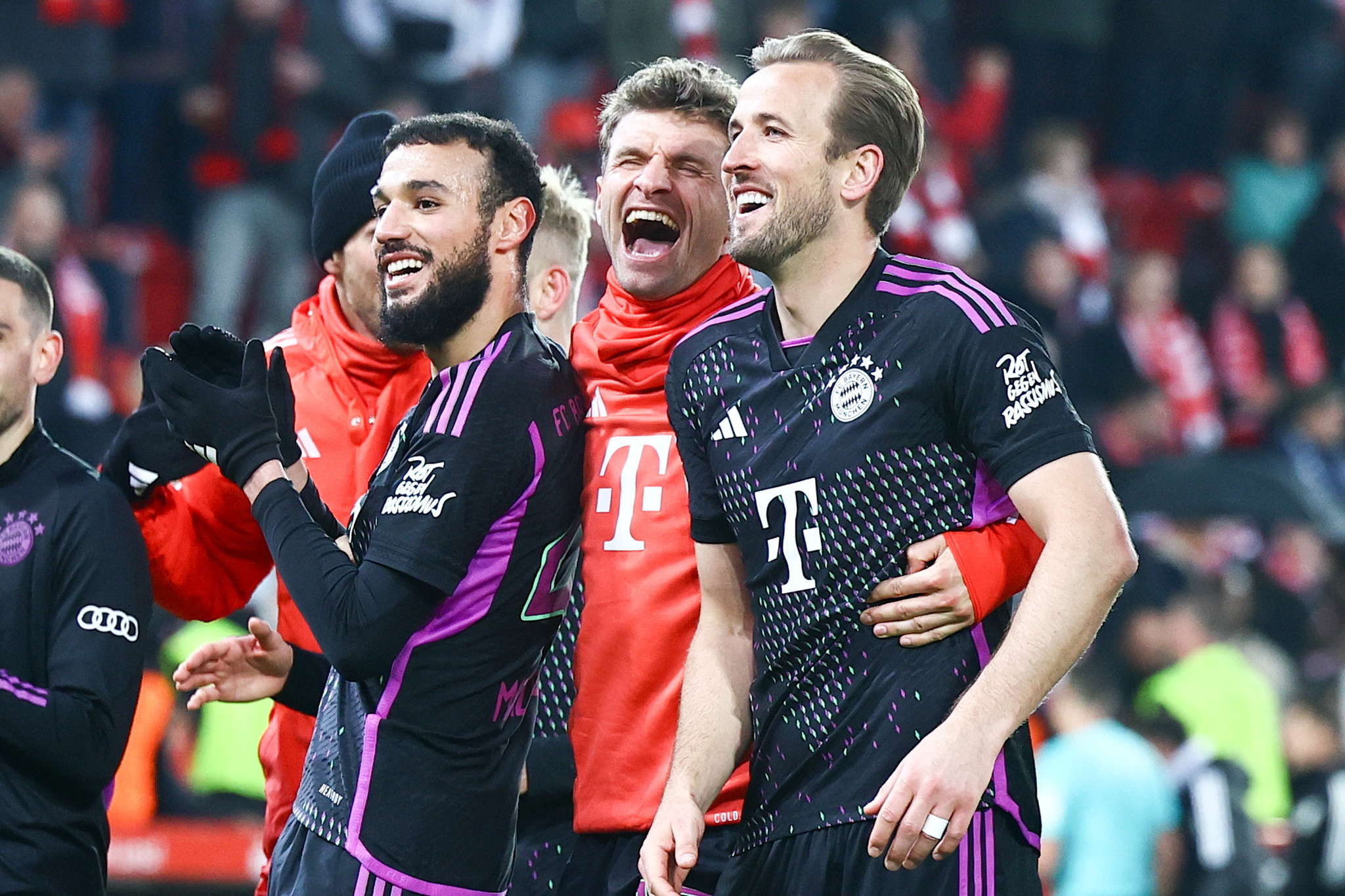 Bayern Munichs Noussair Mazraoui, Thomas Mueller and Harry Kane celebrate