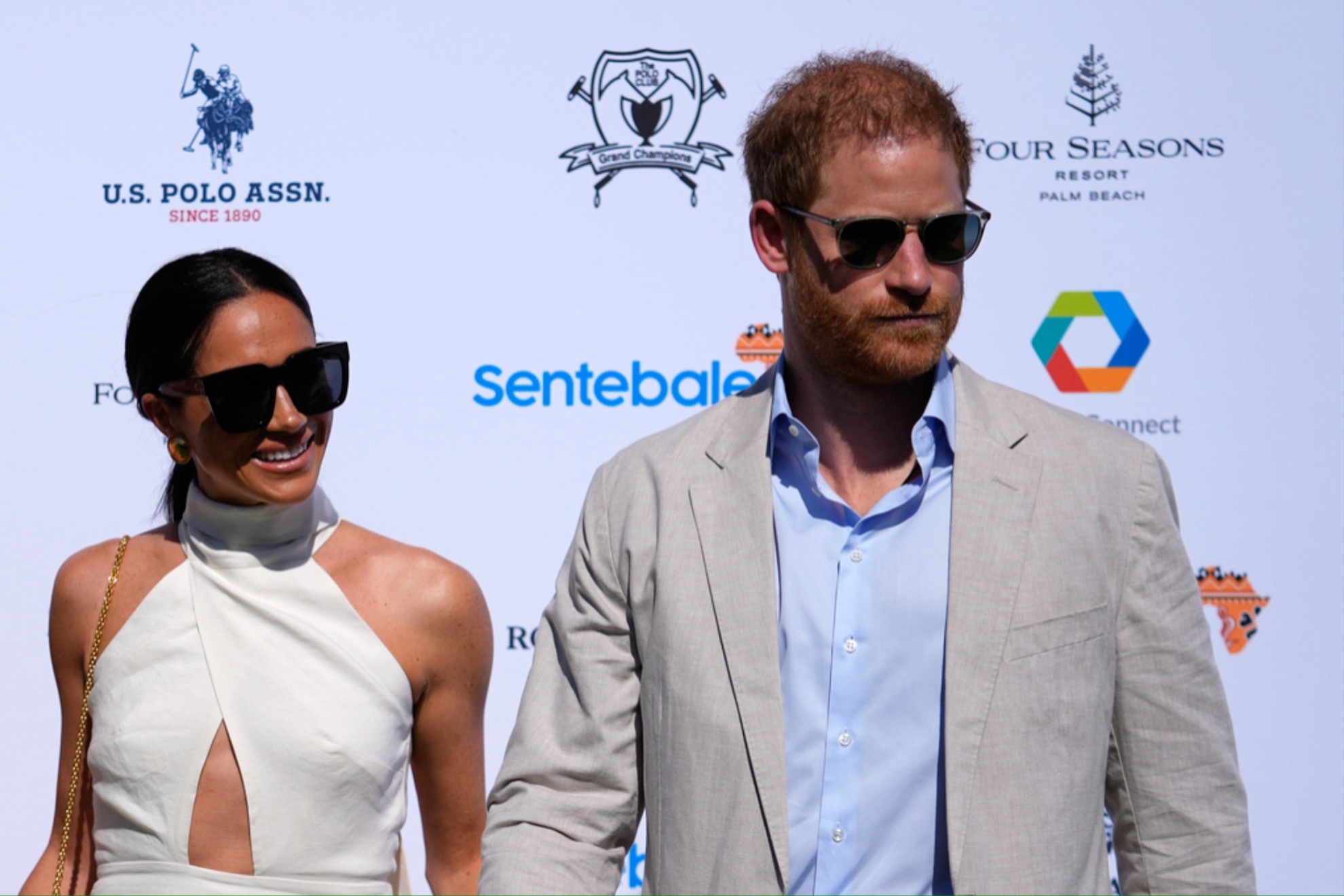 Prince Harry (R) and Meghan Markle arrive for the 2024 Royal Salute Polo Challenge.