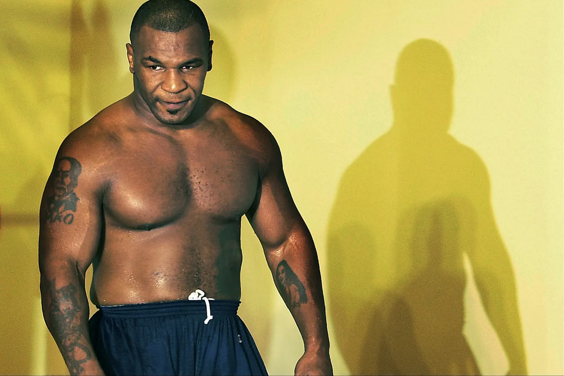 Mike Tyson goes topless and flexes his muscles as he calls out talk show host