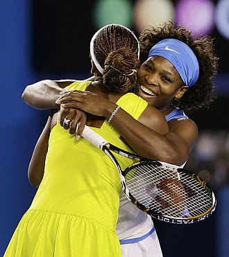 Serena y Venus Williams se abrazan tras ganar el Open de Australia en el dobles.