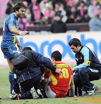Dan Carter es atendido en el csped del Stade de France tras caer lesionado, en presencia del argentino Juan Martn Hernndez