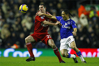 Jamie Carraguer, defensa del Liverpool, ante Steven Pienaar, del Everton