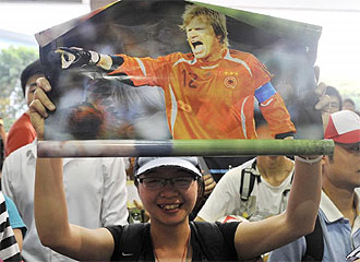 Una seguidora china muestra un poster de Kahn.
