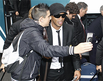 Un aficionado se hace una foto con Ronaldinho a su llegada a Madrid.
