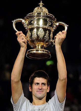 Djokovic celebra su victoria ante Federer alzando el trofeo de Basilea