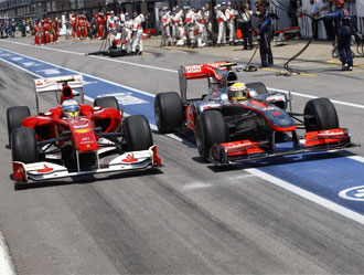 Alonso y Hamilton luchan en el carril de boxes