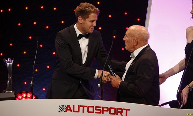 Sebastian Vettel (26), tras recibir el trofeo de manos de Sir Stirling Moss (84).